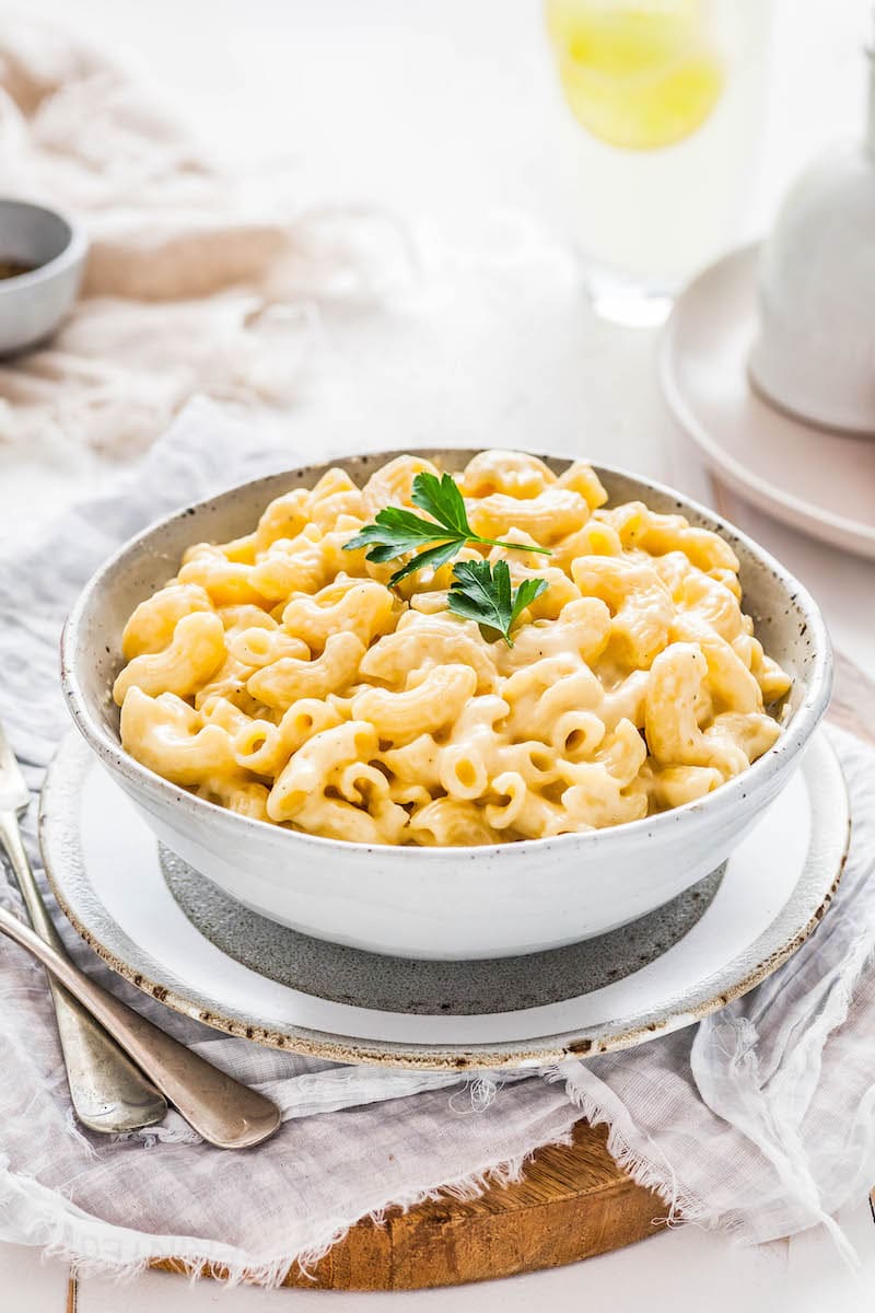 A white bowl filled with homemade mac and cheese. 