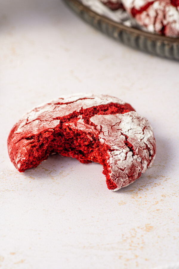 A red velvet cake mix cookie with a bite taken from it.