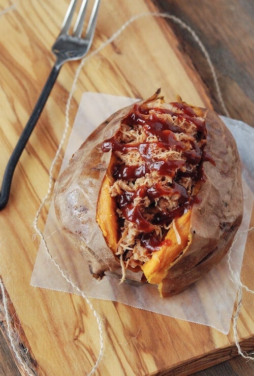 A pulled pork sweet potato on a cutting board