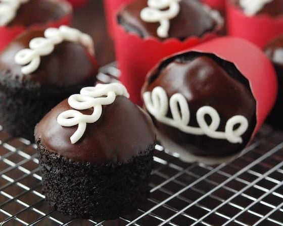 Homemade Hostess Cupcakes in red wrapper on a cooling wrack
