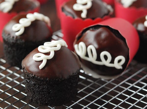 Homemade Hostess Cupcakes in red wrapper on a cooling wrack