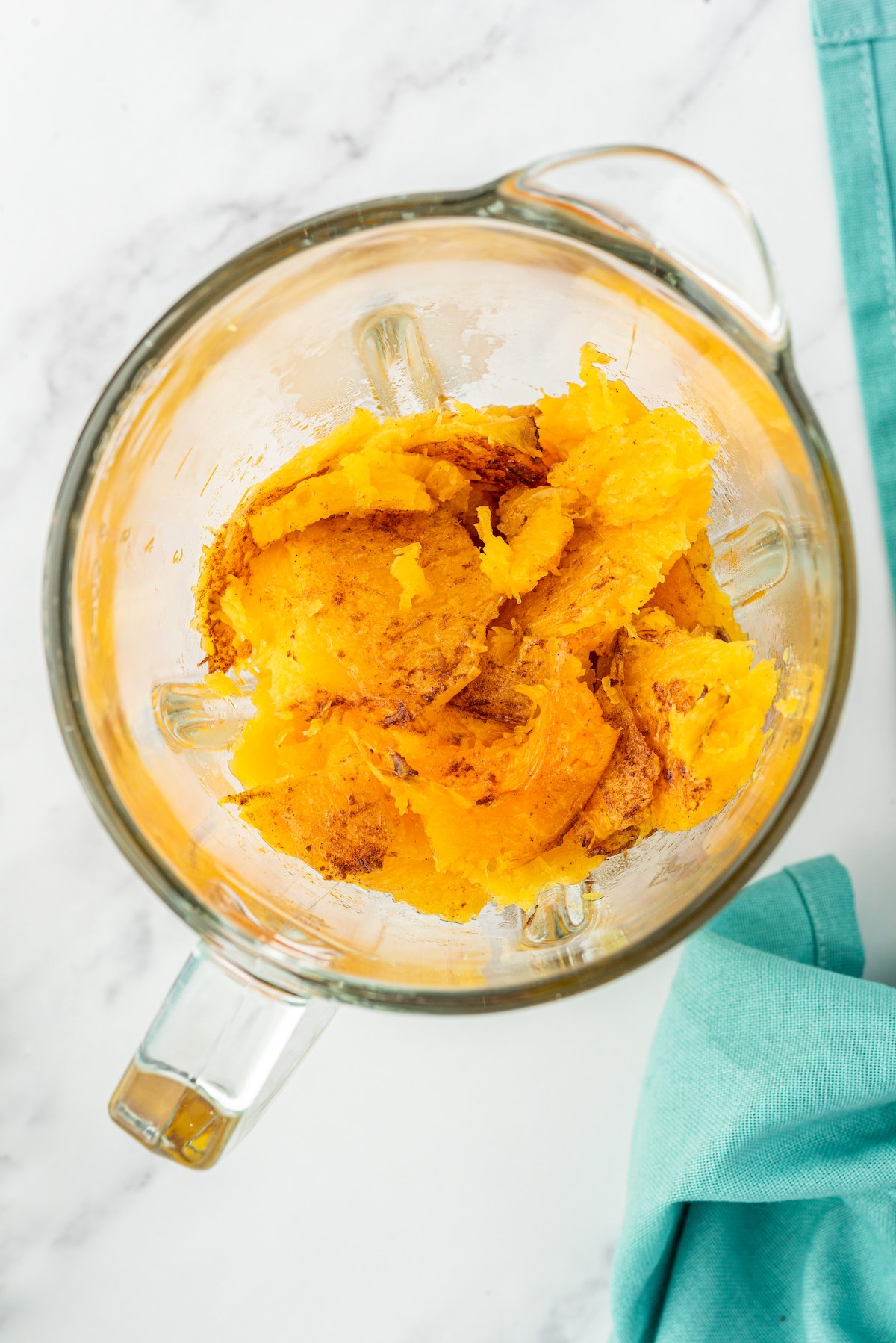 cooked chunks of butternut squash in a blender cup