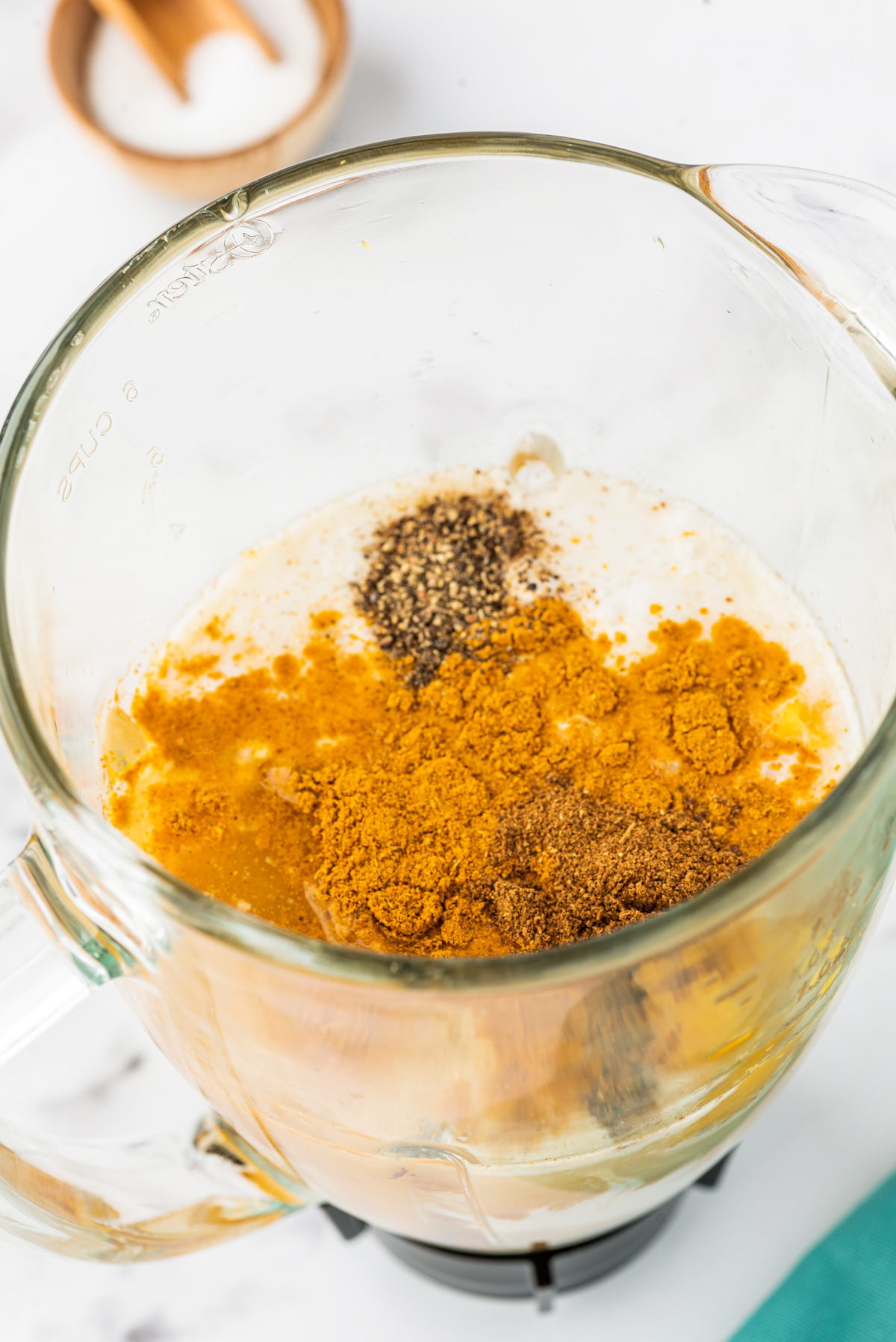 cooked chunks of butternut squash and spices on top in a blender cup