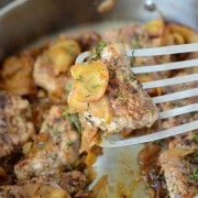 Spiced Pork Tenderloin with Sautéed Apples in a stainless steel pan