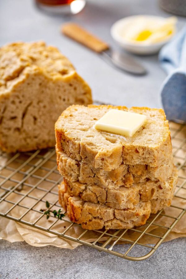 A stack of beer bread slices topped with butter. 