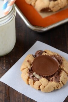 Peanut Butter Cookie topped with a large Reese's Peanut Butter Cup with a glass of milk