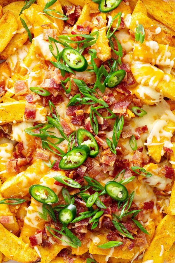 Seasoned cheese fries loaded with toppings.