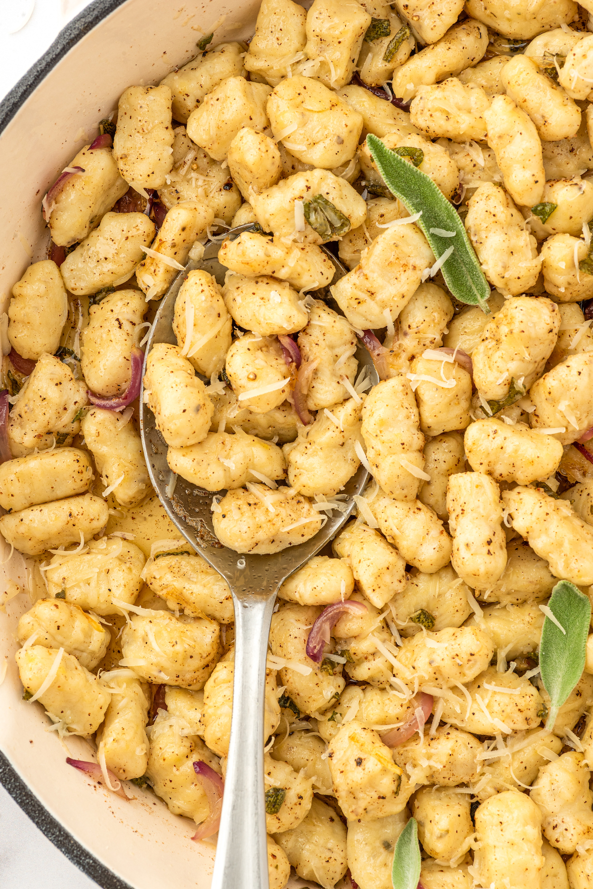 Close-up shot of homemade gnocchi in a skillet with brown butter sage sauce.