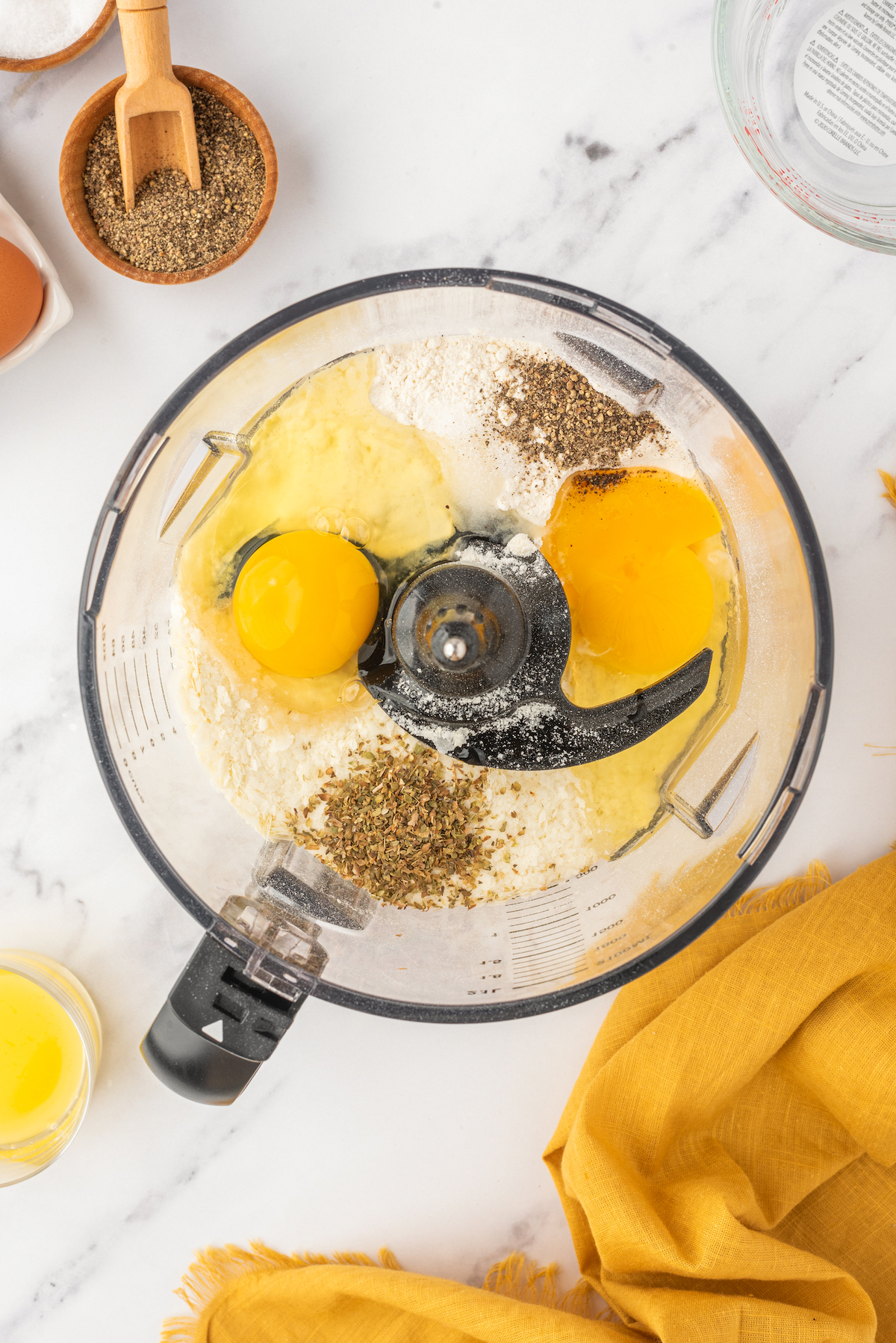 Eggs, flour, and other ingredients in a food processor.