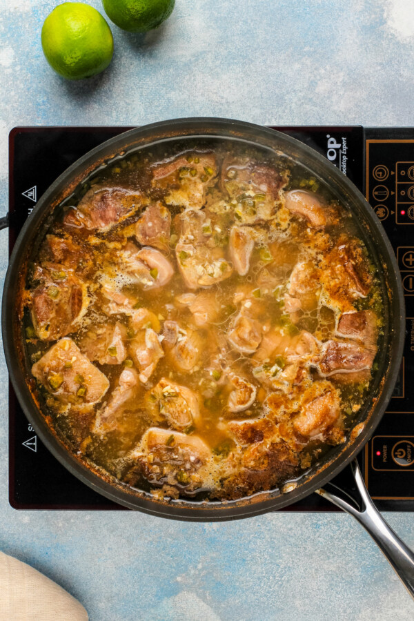 Simmering the pork in the flavorful broth in the pot. 