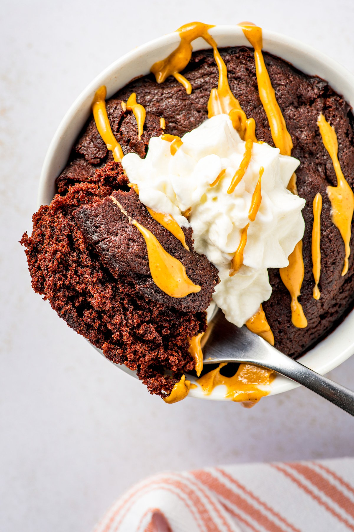 Lifting a bite of chocolate mug cake with a fork.