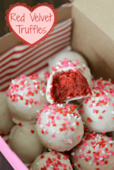Valentine's Day Red Velvet Truffles topped with red, white, and pink heart sprinkles in a pink box