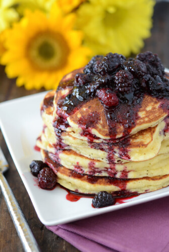 Stack of Sweet Hoecakes with Blackberry Rum Sauce on a white plate