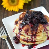 Stack of Sweet Hoecakes with Blackberry Rum Sauce on a white plate