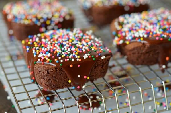 Triple Chocolate Glazed Brownies with colorful sprinkles on a cooling rack