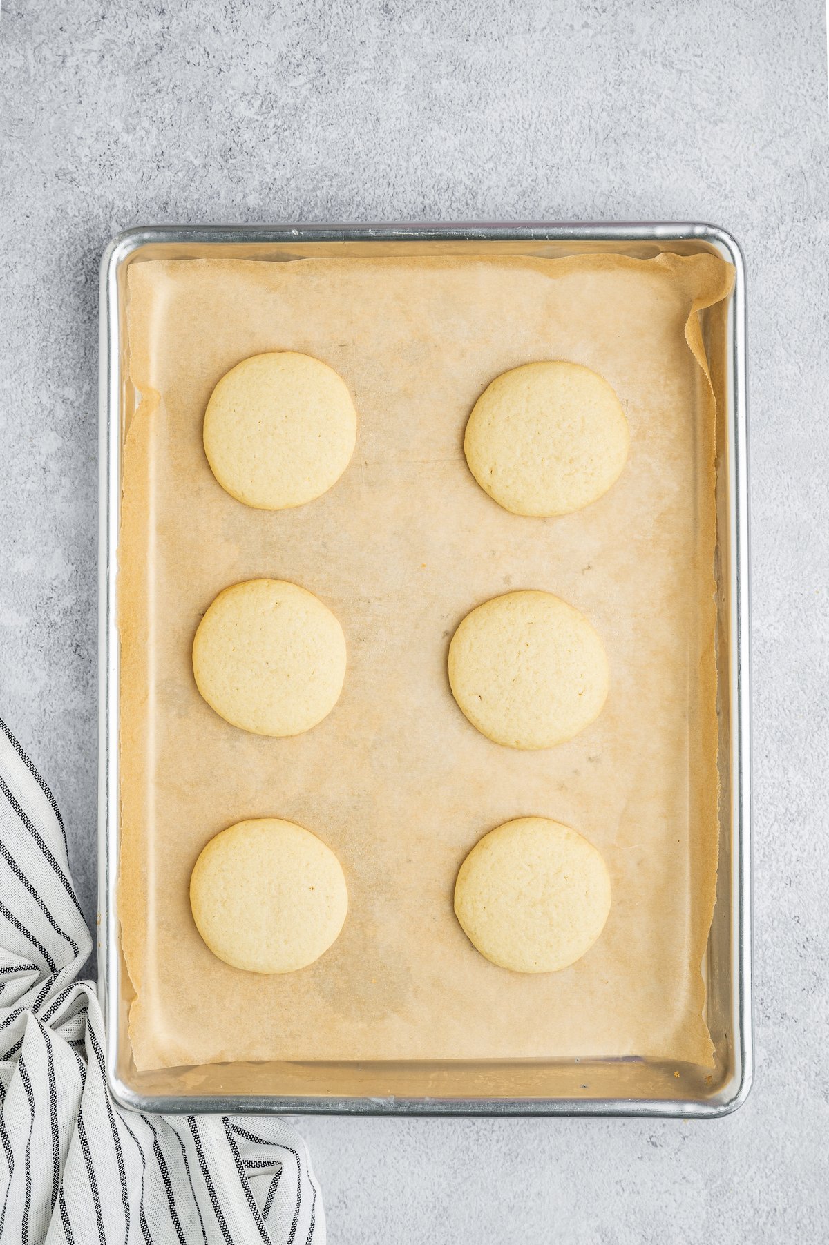 Baked meltaway cookies on a cookie sheet.