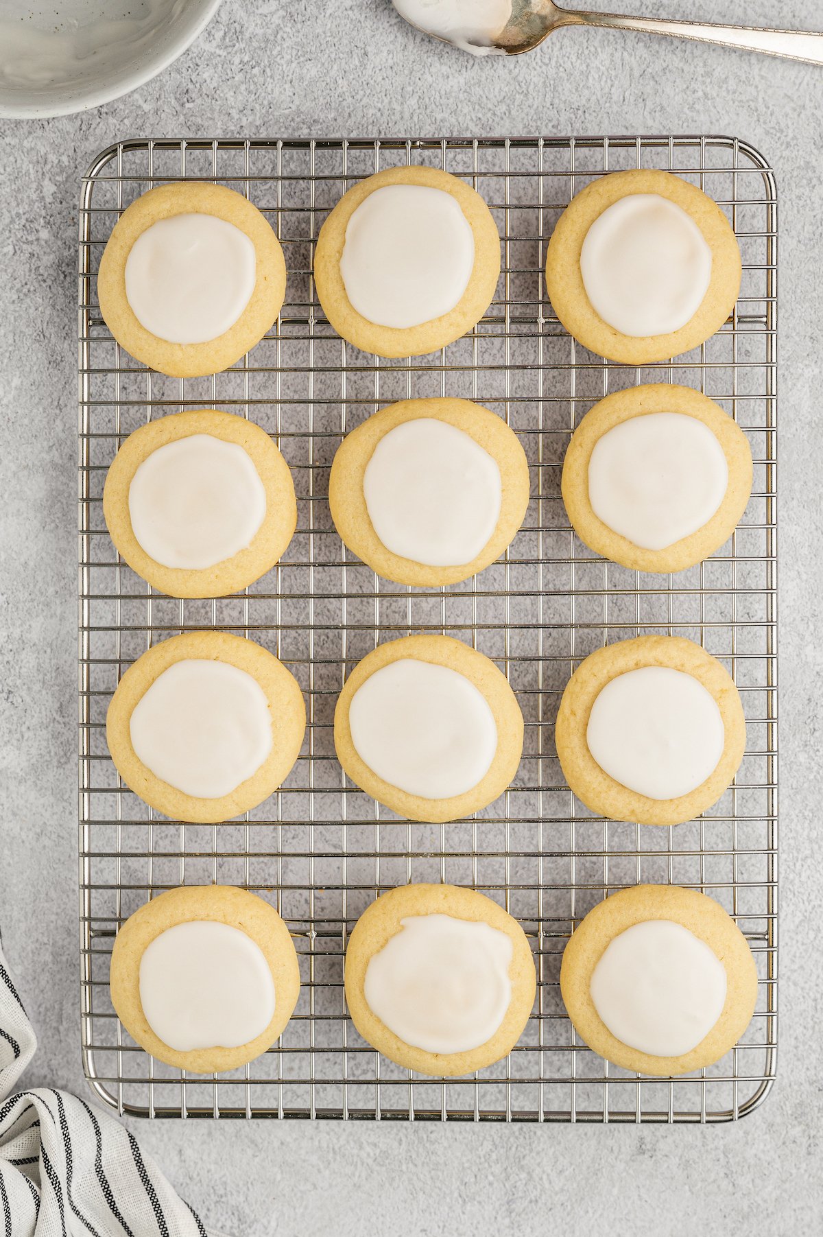 Glazed almond cookies on a rack.