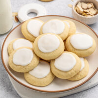 A plate with almond cookies piled on.