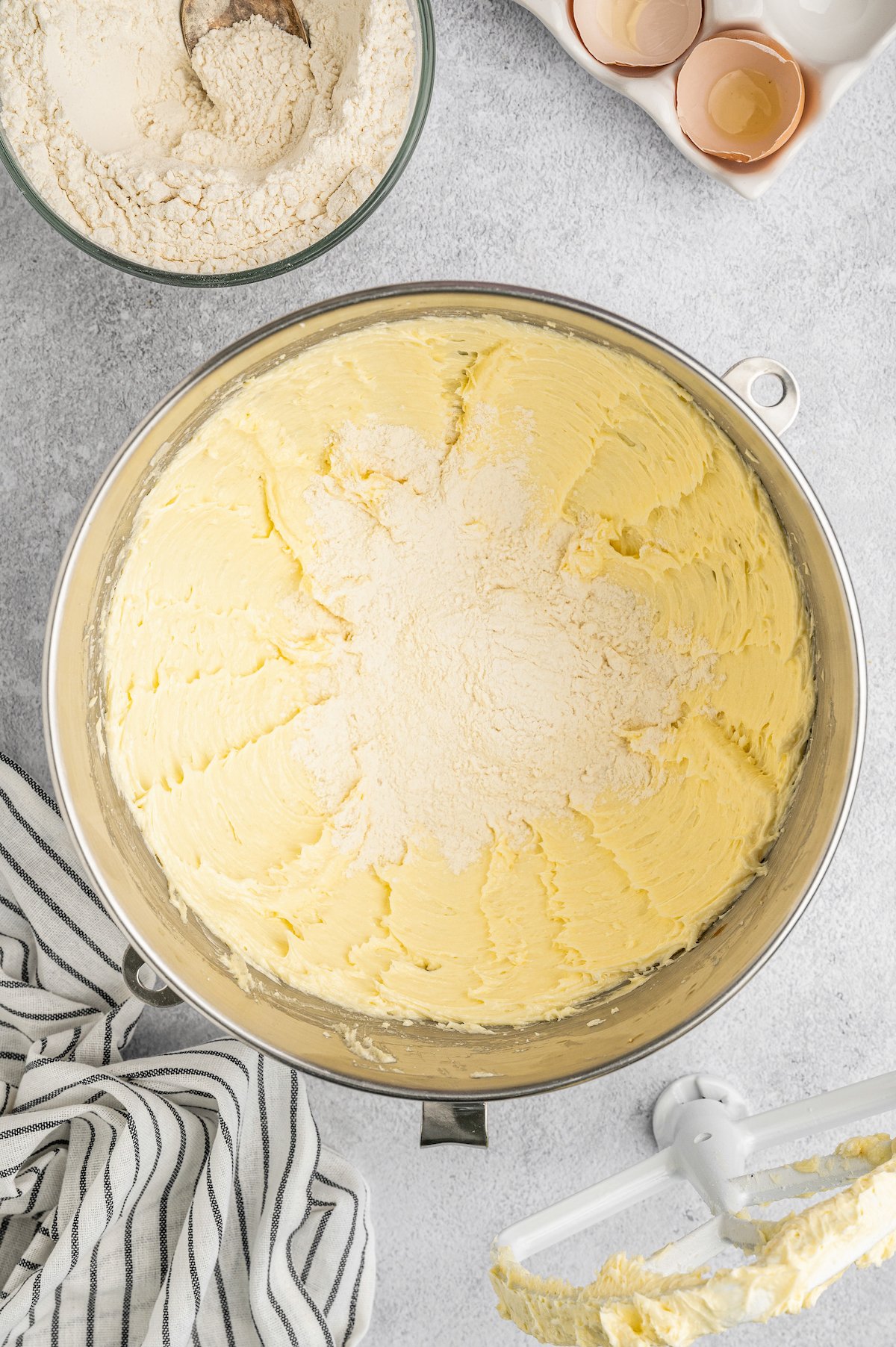 Creamed butter and sugar in a mixing bowl with dry ingredients added.