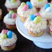 Coconut Cupcakes topped with Robin's Eggs on a white cake plate