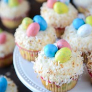 Coconut Cupcakes topped with Robin's Eggs on a white cake plate