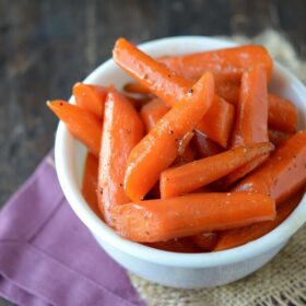 Candied carrots in a small white dish.