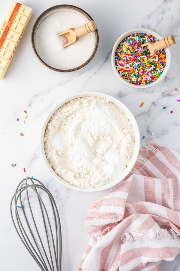 Combining the dry ingredients in a bowl with a whisk.