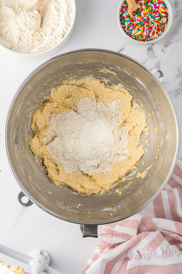 Combining wet and dry ingredients in a stand mixer.