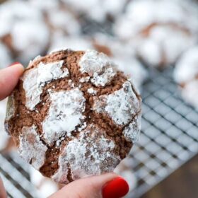 Woman showing Chocolate Crinkle Cookies.