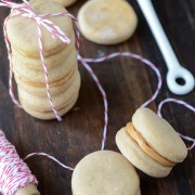 Peanut Butter Sandwiched Dog Treats stacked - some tied with red and white string.