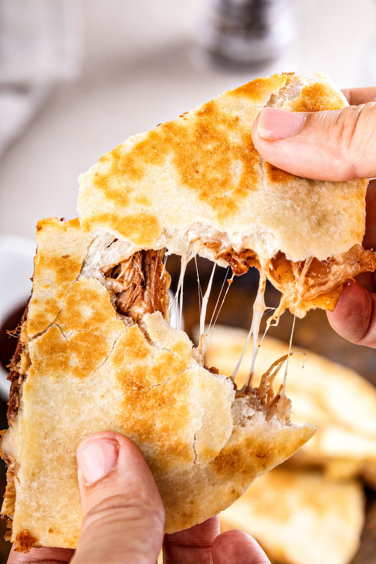 Pulling apart a pulled pork quesadilla.