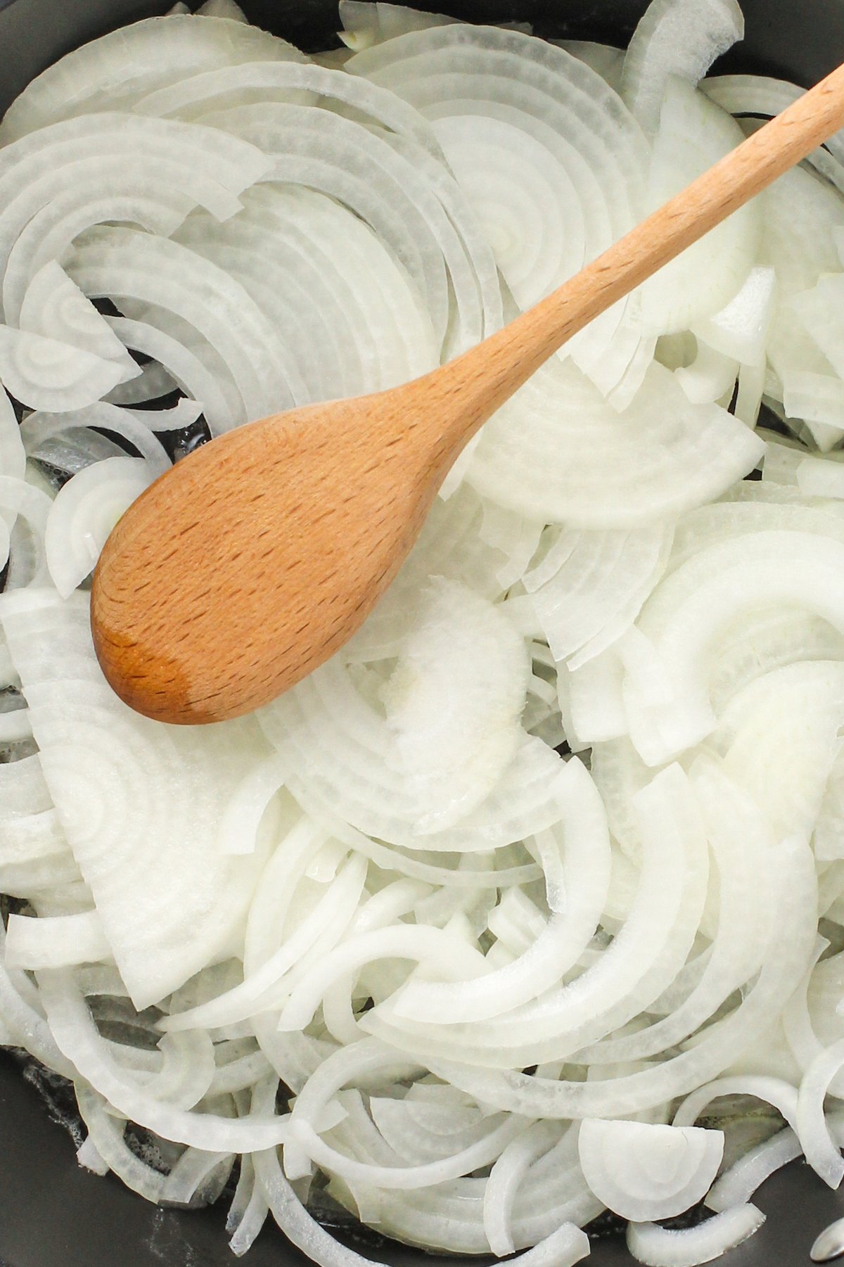 Adding the onion to the pan.