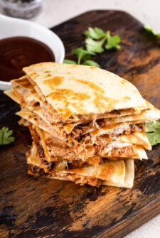 Sliced pulled pork quesadillas on top of one another.