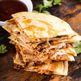 Sliced pulled pork quesadillas on top of one another.