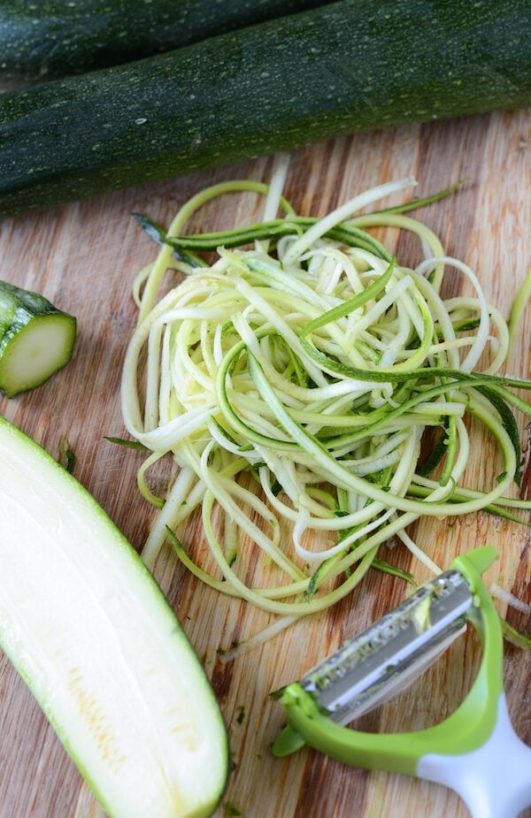Zucchini noodles created by a hand held peeling tool.