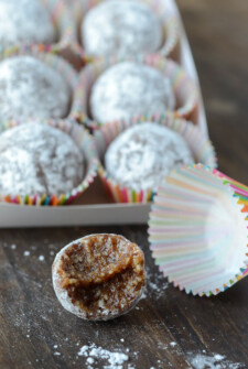 Almond Date Truffles in Rainbow Wrappers Topped with Powdered Sugar