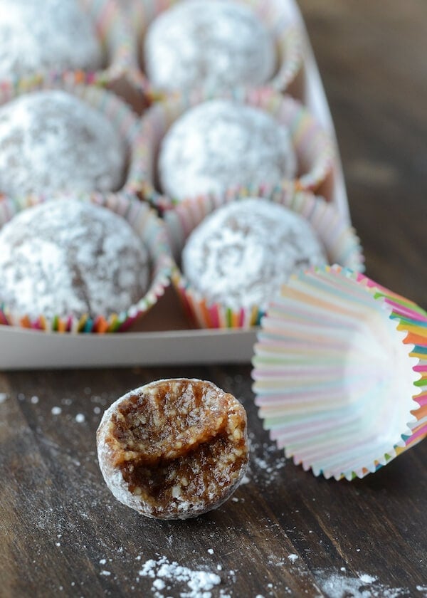 Almond Date Truffles in Rainbow Wrappers Topped with Powdered Sugar