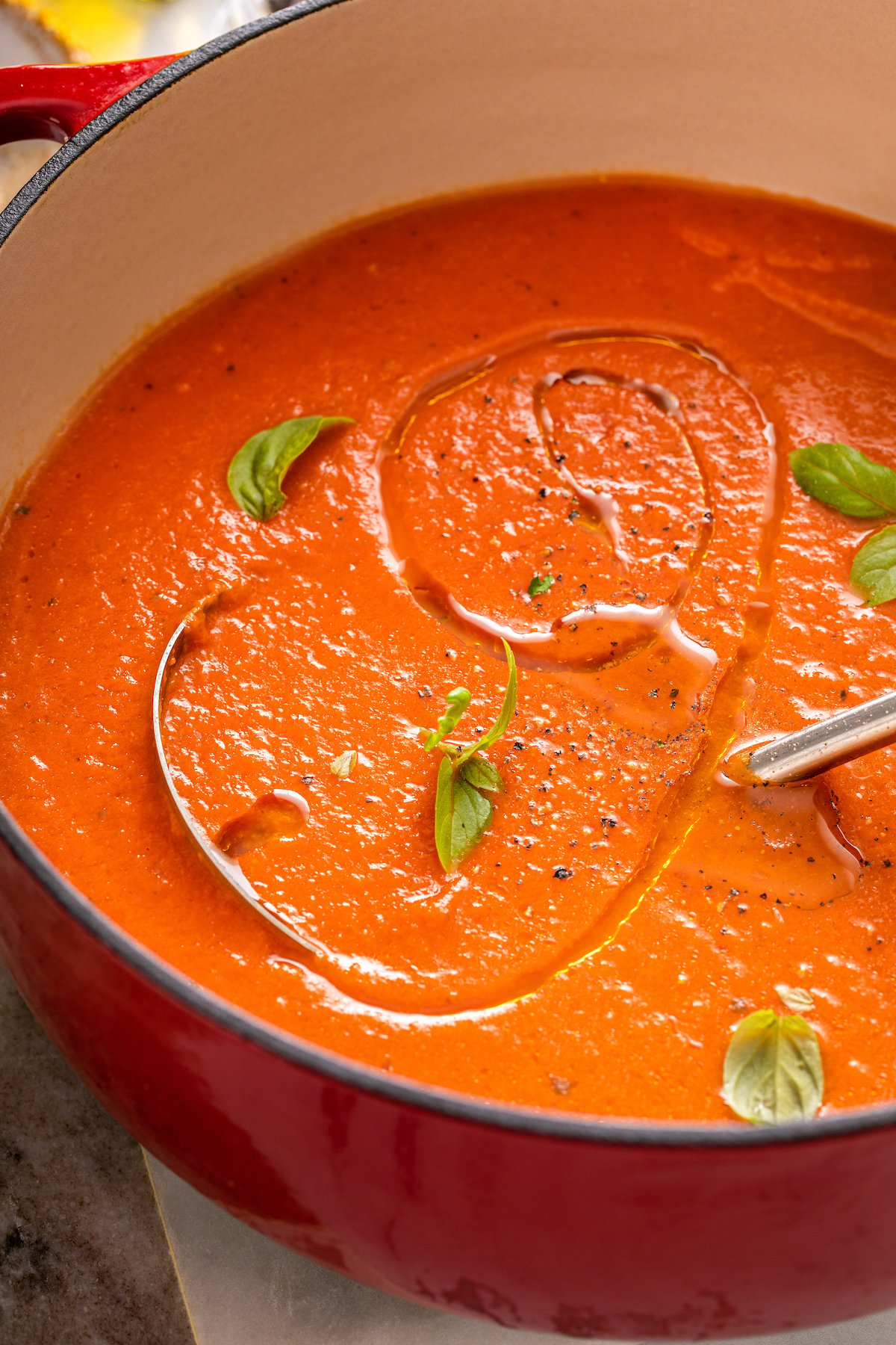 Creamy tomato soup topped wit herbs.