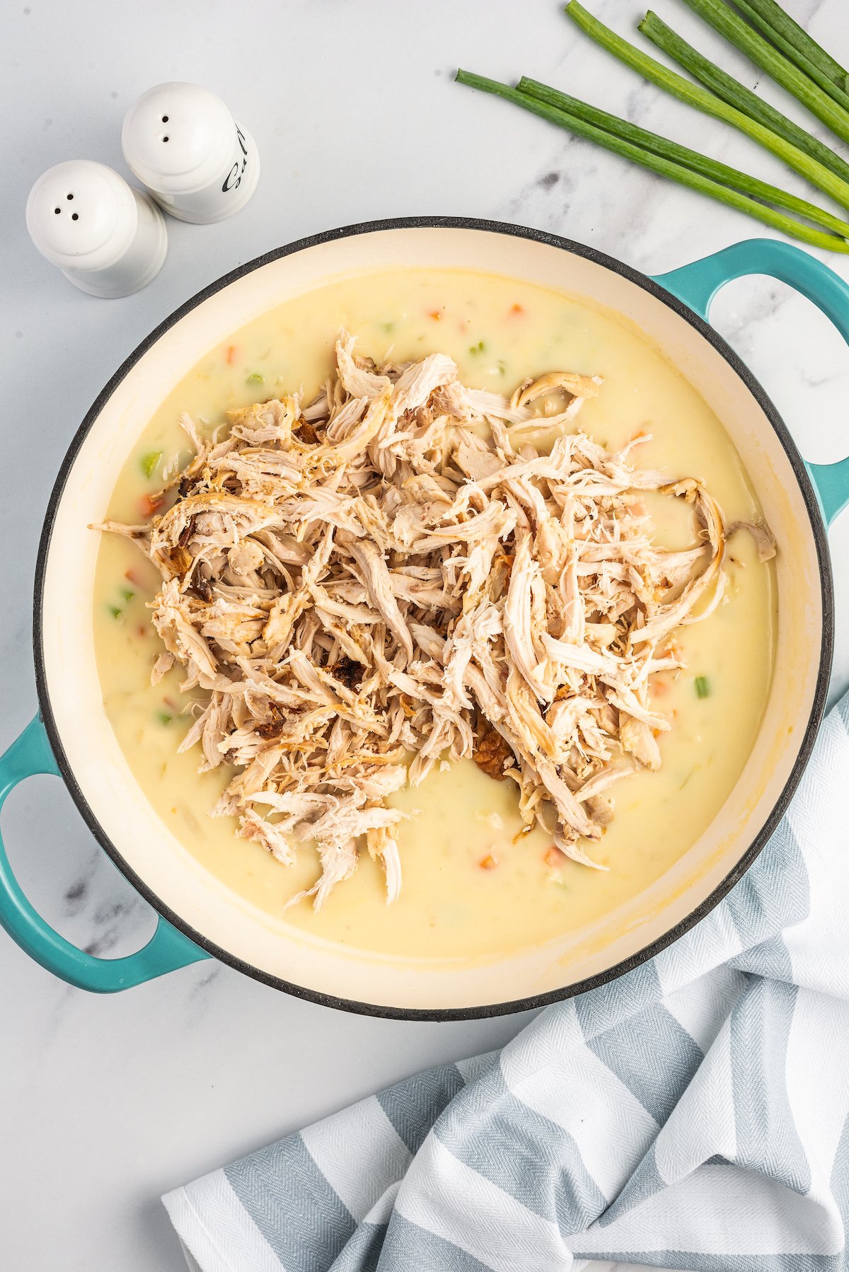 Shredded chicken added to a creamy sauce.