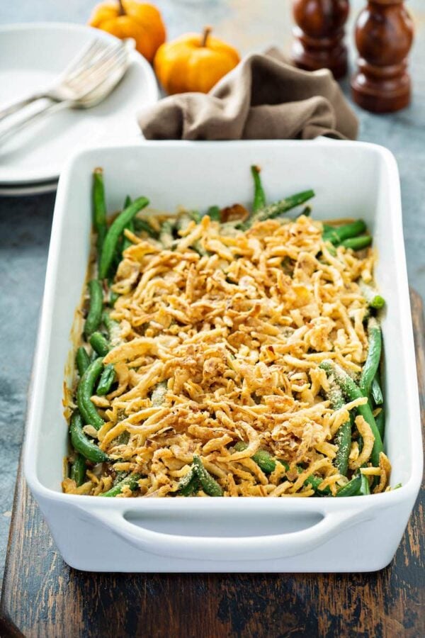 Green Bean Casserole in a white baking dish with french fried onions on top