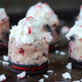Peppermint Oreo Mini Cheesecakes topped with whipped cream and crushed peppermint