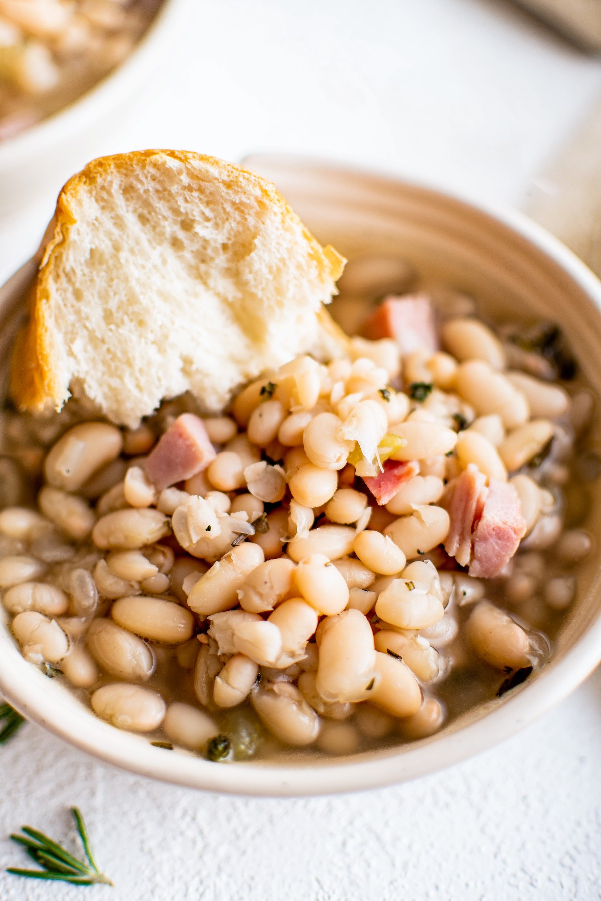 Bean soup with a hunk of bread in it.