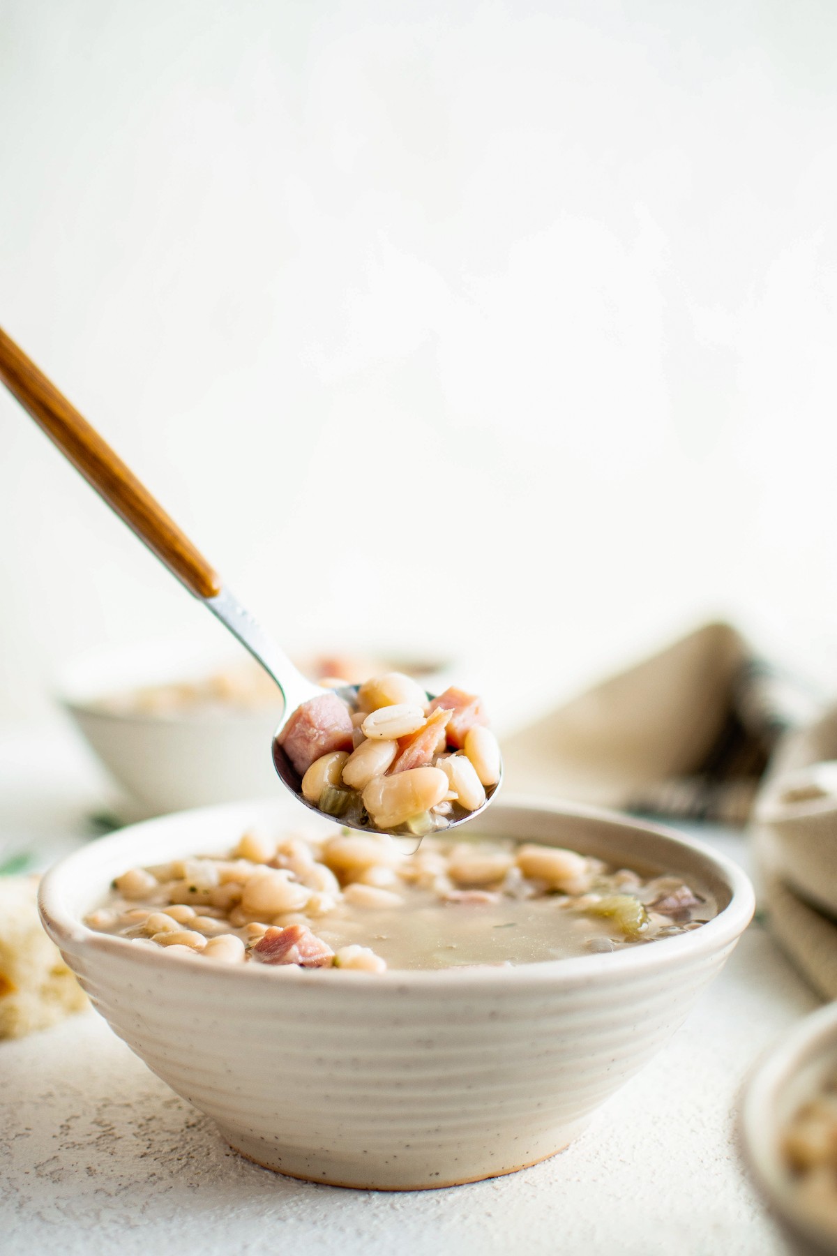 Spoonful of ham and bean soup.