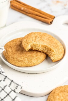 Two snickerdoodles on a white plate