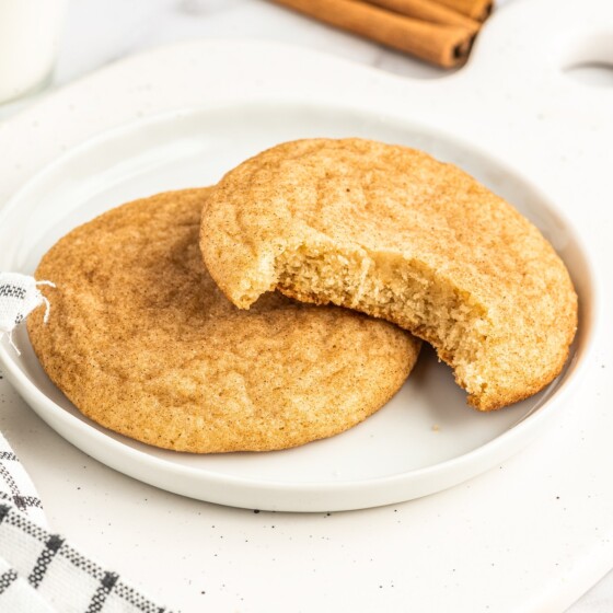 Two snickerdoodles on a white plate