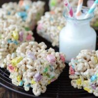 Eight Lucky Charm Marshmallow Treats on a Serving Platter with a Cold Glass of Milk