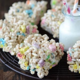 Eight Lucky Charm Marshmallow Treats on a Serving Platter with a Cold Glass of Milk