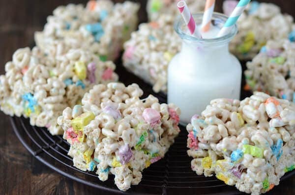Eight Lucky Charm Marshmallow Treats on a Serving Platter with a Cold Glass of Milk