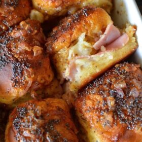 Baked Mustard, Ham & Cheese Sliders - These soft melted ham sliders are drenched in sauce and served warm out of the oven. It's no wonder they are one of my most popular recipes!