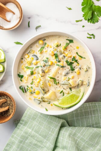 Creamy poblano corn soup with cilantro in a bowl.